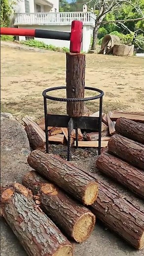 Workers are using fixed chopping tools to cut firewood.