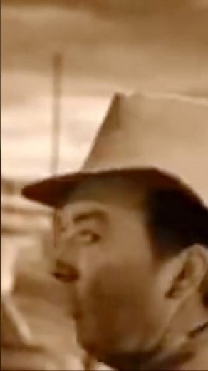 The Tinman sneaks a mug into the camera during the farm scene in “The Wizard of Oz”