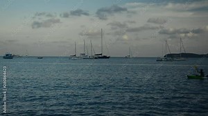 Scenery of Ao Yon Bay with unrecognizable peoples playing kayak in the sea, Beauty of andaman sea with yachts under cloudy blue sky in phuket, Thailand.
