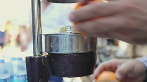 Orange squeezer used by a man - Free Stock Video