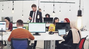 Coworking freelance space. Ux developer and ui designer looking at laptop screen for successful design approved at modern office.Creative digital development agency