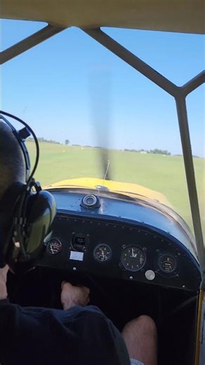 Aeronca champ taking off grass strip