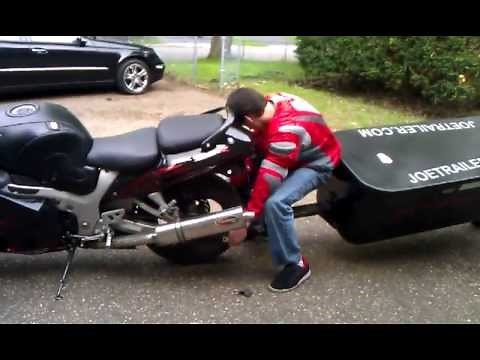 Single wheel pull behind motorcycle trailer.