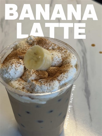 day 3 of recreating @The Nitro Bar lattes at home 🍌☕️ today’s recipe is the caramelized banana latte! the nitro bar doesn’t usually have whip on theirs…but ofc I had to add it for fun. my recipe is coming this week I promise!! comment if you want the banana coffee syrup recipe & FOLLOW to see what latte is next 🫶🏼 #bananabreadlatte #thenitrobar #coffeerecipe #coffeeathome #icedlatte
