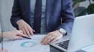 Two professionals analyzing a pie chart during a strategic business meeting. Business meeting with graph analysis