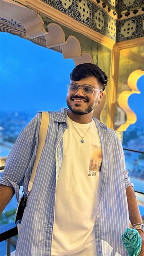 Dhiraj | Stylist on Instagram: "Day-18 of Showing My outfits 365 Days 🧿♥️ Baat to sochne vali hai vaise , Aesthetic ke chakkar me hum kuch bhi kiye jaa reh hai 🥺🫱🏻‍🫲🏼🙂 #fitsWD #mensstyle #udaipur #ootdfashion #inspo Blue lining shirt , camera bag , white pants , Pinteresty outfit 🌻✨"