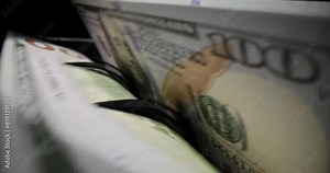Counting dollar bills with special device in equipped bank. Concept of storing and counting money in economic institution macro slow motion