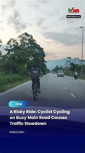 A Risky Ride: Cyclist Cycling on Busy Main Road Causes Traffic Slowdown