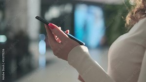 Alternative macro close up of an young businesswoman hands busy working on smartphone for send emails and surf on a web browser.