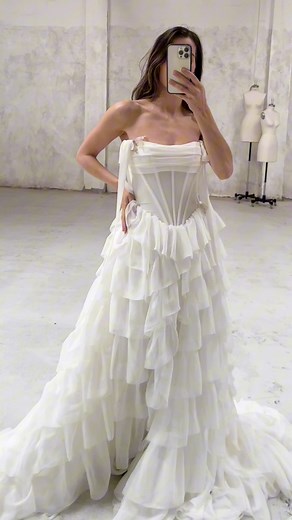 Fitting moments with Jacqueline 🤍 Jacqueline's tiered ruffle skirt and exposed boning details embody the perfect combination of reimagined history with playful romance. The Jacqueline gown is guaranteed to make you feel your most confident and beautiful self on your special day! Seen here styled with the Papillon veil in fawn. Tag a bride-to-be who needs to see this🕊#JacquelineGown #RueDeSeine #RueDeSeinebridal #weddingdress #weddingdressinspo #weddinginspo #weddingideas #bridetobe #engaged #e