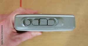 Pressing buttons on a cassette player, close-up, top view. Play button, stop, fast forward, rewind the tape.