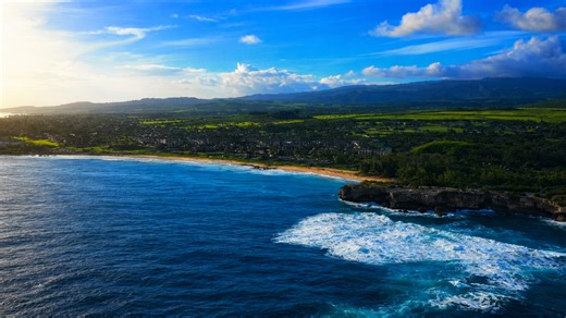 Dramatic coastal cliffs overlooking waves and sandy beaches