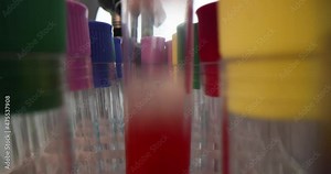 Scientist laboratory assistant takes out test tubes with liquids