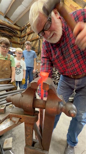 Part 7 of forging Box Jaw Tongs with John McLellan! Here the extra mass on the tip of the bit is finished being spread and now getting cleaned up using a vice to support it. The goal is getting the tip flat and perpendicular while supporting the shoulders of the wings. The post vice makes this quick and efficient. Keep the jaws just slightly loose so the piece is supported by the wings not being gripped by the vice. Once that is done dress the final shape at the anvil. Next those sides will have