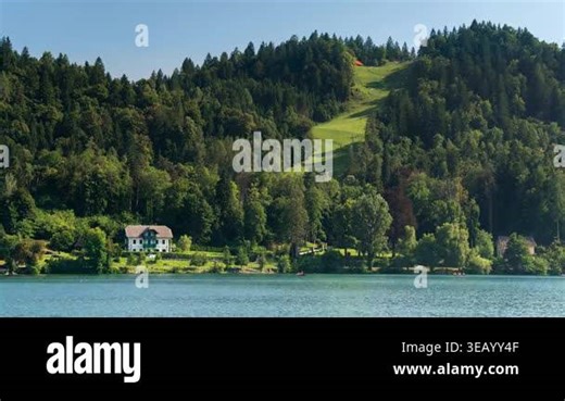 Bled, Slovenia - August 11, 2025: Timelapse. Traditional Alpine Villa and Lush Green Hillside Reflected in the Calm Turquoise Waters of Lake Bled, Slovenia during Summer A picturesque landscape featuring a classic white villa nestled at the foot of Stock Video Footage - Alamy