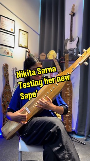 Talented 12-Year-Old Playing Traditional Sape' Instrument