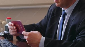 The immigration control officer verifies passport identification data.