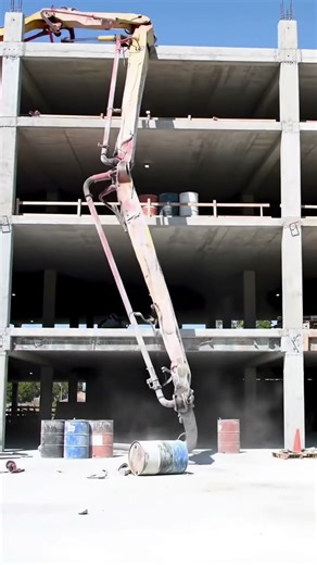 Concrete pump boom destroys barrels after a pour. #construction