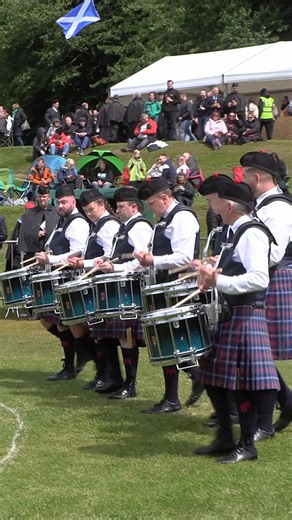 Pipe Major Ali Hutton leading Livingston Caledonia Pipe Band as they maeched in to start their Grade 3A bands competition final at the 2024 British Pipe Band Championships. These were held at Forres on Saturday 8th June 2024 and the band, wear Livingston Caledonia tartan, marched in playing Knightswood Ceilidh into The Ewe Wi the Crooked Horn. Hosted by a partnership between YBD Music Ltd and the Royal Scottish Pipe Band Association, the Championship involved over 100 bands and nearly 4,000 pipe