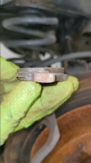 2006 Chevy Malibu rear disc brake pads and rotor inspection, uneven wear angled surface portrait RR