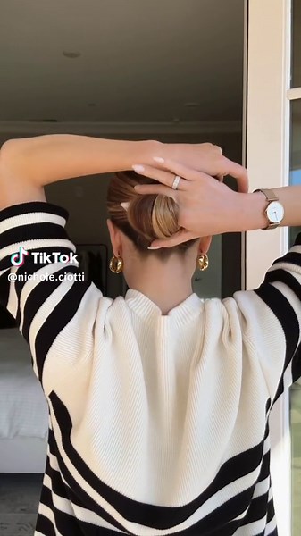 The Infinity Loop 💁‍♀️ Gather hair into a ponytail. Pull tail up and over the pointer finger, wrapping it behind the hand that’s holding the base of the ponytail. Reach across neck and continue pulling the hair around to form a bun. Repeat as many times as necessary. Insert hair stick in between your pointer finger and the inside of the bun. Weave stick through so that it comes out on top of the other loop ♾️ #hair #hairtutorial #updo #hairstyles