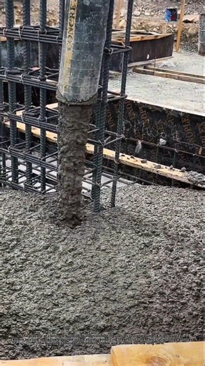 The process of casting a building foundation footing using a concrete pump.