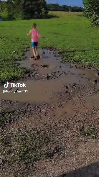Everyone likes a good fall!🤷‍♀️ (This child has so much fun in the mud!) #mud #puddle #childhood #country #immunebooster #joy #muddy #fall #laugh #momlife