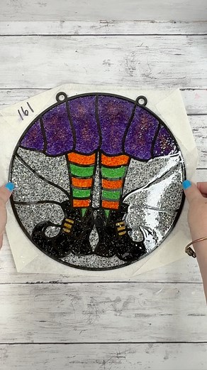 13K views · 176 reactions | Peel the paper transfer tape off of this faux stained glass sun catcher I made using crushed glass and resin. So fun for Halloween!  #halloween2025 #fauxstainedglass #shatteredglass #resincrafts #witchdecor #suncatcher #halloweendiy #spookyvibes | Amber Strong DIY | Facebook