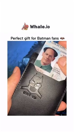 𝗗𝗢𝗢𝗠𝗘𝗗 ⚠ on Instagram: "The video showcases a Batman-themed wallet that features an embossed Batman logo on its surface. As a driver’s license is inserted into the wallet, the Batman logo aligns with the photo on the license, creating an illusion where the person’s face appears to be part of the Batman mask. This design emphasizes the theme of identity and disguise central to the Batman character. The wallet is presented as a gift for Batman fans, highlighting its unique and interactive de