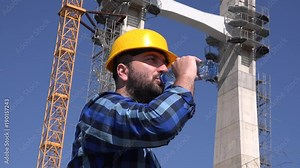 Foreman constructor overseeing building structure development drinking water 4K