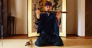 Man, sensei and sword in Japan for martial arts, respect and cultural tradition in dojo. Asian person, weapon and bow in karate school for honor, aikido training and preparation ritual for wellness