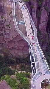 Built between mountain cliffs, the Ruyi glass bridge is a real wonder in Zhejiang Province! Its curved architectural structure, composed of three archways, impresses many. The top section is a convex surface while there is a glass trestle in the middle which tests the courage of tourists now and then. Do you have the courage to walk on it? | China Plus Culture