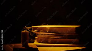 Books and candle. Fire and smoke. Library in darkness.