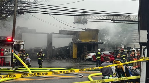 Massive fire burns through auto shop in Fort Lee