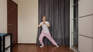 Woman dancing at home, music and motion, young dancer embracing a healthy lifestyle.