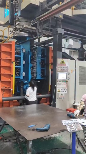 techy Universe | A high-capacity industrial blow molding machine in the middle of a production cycle, likely within a heavy manufacturing facility. A large,... | Instagram