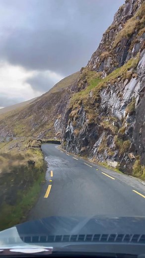 Conor Pass is one of Ireland’s highest mountain passes at 1,496 ft 😳🚗 This narrow road carves through the Dingle Peninsula, with a cliff on one side and a jaw-dropping valley on the other 💨⁠ The drive’s short (around 40 seconds) but unforgettable. There’s parking, viewpoints, and even a little waterfall! | The Irish Road Trip