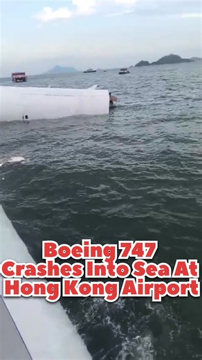 Boeing 747 Crashes into Sea at Hong Kong Airport This is the stark aftermath at Hong Kong International Airport, where an Emirates SkyCargo Boeing 747 met a tragic end. The massive freighter is seen here partially submerged, its nose and front landing gear resting in the water after it violently veered off the runway and breached the seawall. The aircraft's destructive path is clear—from the shattered barrier to its final position in the channel. While the four crew members on the jet survived t