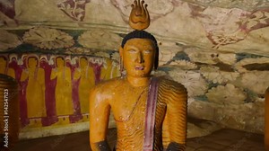 Beautiful ancient Buddhist statues and Buddha monuments in Dambulla cave temple interior with traditional architecture in Sri Lanka. Asia landmarks video background