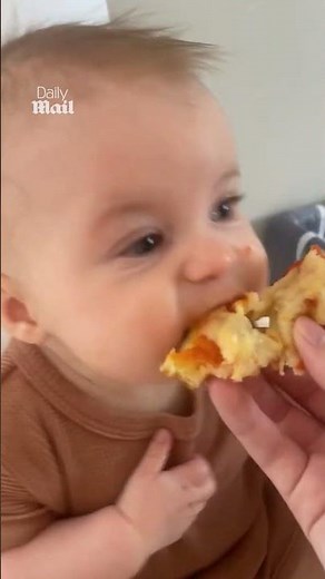 Adorable baby tries pizza for the first time