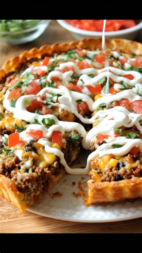 TACO PIZZA RECIPE 🌮🍕 This Taco Pizza combines the best of both worlds — a crispy crust loaded with seasoned beef, cheese, and all your favorite taco toppings. It’s fun, flavorful, and perfect for parties or a family dinner! 🧂 Ingredients: For the crust: 1 refrigerated pizza dough (or homemade) For the taco layer: 1 lb ground beef 1 packet taco seasoning 2/3 cup water For toppings: 1 can refried beans (optional: warm for easy spreading) 1 cup salsa or taco sauce 2 cups shredded cheddar cheese 