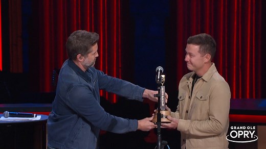 Watch the full moment where Scotty McCreery officially becomes a member of the Grand Ole Opry! Opry star Josh Turner gave a heartfelt speech alongside Randy Travis stating "country music's in great shape" with Scotty before handing him the member award. We'll be thinking about this special moment for a long time! | Grand Ole Opry
