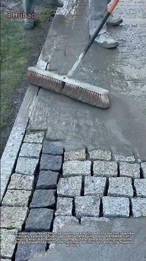 "Hand-Pushed Cement Spreading: Worker's Smooth Brush Technique for Perfect Road Leveling!"