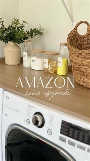 ✨Laundry Room Upgrade ✨ Can you believe I found this countertop for your washer & dryer that looks like white oak on Amazon? Making this space functional & aesthetically pleasing with the added counter space and new glass containers. I also grabbed a holder for the ironing board and iron for the back of the door to tidy up this space! LINK: https://amzlink.to/az0Kzy4yfSZEq #founditonamazon #amazonhomefind #laundrycountertop #amazonhomehack #homeupgrades #homeswithpurpose | Modern Farmhouse with 