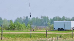 Helibucket - Bucket On a Cable Carried By Helicopter To Deliver Water For Aerial Firefighting. - wide tracking shot
