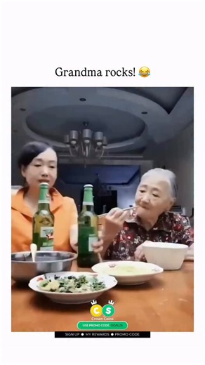 UNIVERSAL KNOWLEDGE on Instagram: "This viral video captures an elderly Asian woman enthusiastically clinking and sipping green beer bottles at a family dinner table laden with rice and greens, her animated expressions contrasting typical portrayals of seniors for a lighthearted take on aging gracefully. - Posted by Thebestfigen, a account specializing in positive viral clips, the content exploded with 10k+ likes and 576k views within days, drawing replies praising her vibe like “Don’t get in th