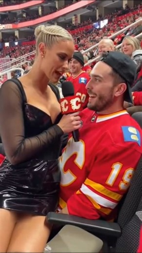 slidur on Instagram: "NHL Reporter Visits Scotiabank Saddledome to Interview Fans #nhl #nhlhighlights #calgaryflames #funnyvideos #funny A Calgary Flames in-arena reporter slips on a stair at the Saddledome and lands straight in a fan’s lap, lifting her mic instinctively to keep it clear. With calm authority, she tells him he’s “going hard already” before warning that guys who brag about having plenty left usually gas out fast. Leaning in, she advises him to pace himself or risk being empty earl