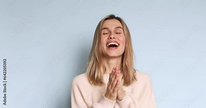 Surprised excited happy woman. Portrait of beautiful young girl with ecstatic face expressions, she claps hands. Female shocked model on blue background. Stock Video