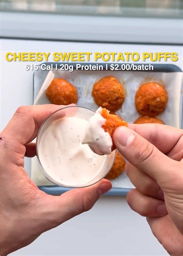 These are cheesy sweet potato puffs. They’re one of the most fun foods I’ve ever made - and because we’re in my kitchen, they’re high-protein and only take a few ingredients. Cheesy Sweet Potato Puffs 615 Cal | 20g Protein | $2.00/batch This all starts with a boiled sweet potato. Take off the skin, and then mash with these ingredients: 2oz tapioca flour 2oz low-fat mozzarella cheese 1 tbsp sugar-free maple syrup Salt & pepper Let this dough chill in the fridge, then form balls, spray with oil an