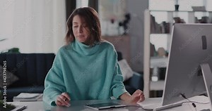 Beautiful Young Caucasian Female Sitting in Cozy Sweater near Computer Monitor Drawing with Digital Pencil Tablet Notepad Graphic Design Making Creative Art Project.